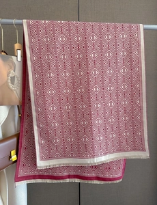 Detailed view of red and white geometric cashmere-feel scarf with delicate tassel fringe