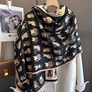 Detailed view of cat pattern knit scarf with soft cashmere-like texture and fringed edges