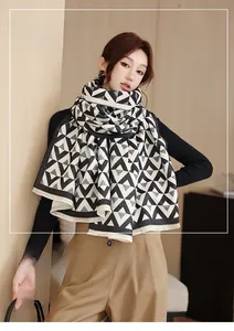 Detail of soft faux cashmere scarf with black and white geometric triangle pattern