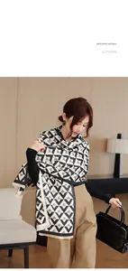 Detail of black and white geometric triangle pattern on faux cashmere winter scarf shawl