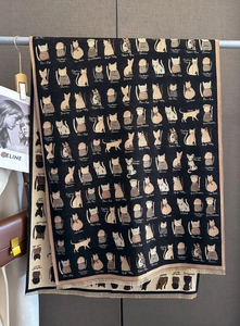 Detail of black cashmere feel scarf with cat jacquard patterns and delicate fringe trim