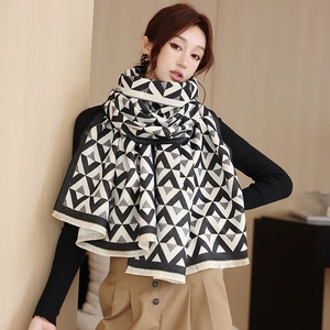Detail of soft black and white V-pattern pashmina scarf featuring delicate fringe edges