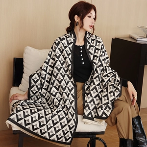 Detail of geometric triangle jacquard pattern and soft fringe on black and white scarf