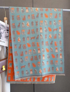 Detail of double-sided cashmere-like scarf with cat patterns and soft fringe edges