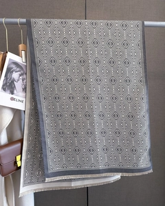 Detailed view of grey and beige diamond pattern scarf with fine short fringe edges