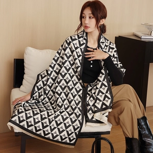 Detail shot of black and white geometric triangle patterned shawl scarf with soft fringes