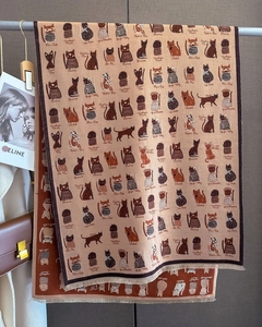 Close-up of cat illustration jacquard scarf with decorative tassels and soft knit texture