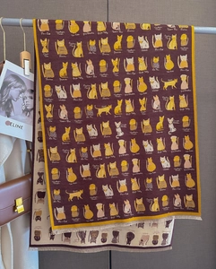 Close-up of cat breed illustrations on thick knitted scarf with tassel edge detail