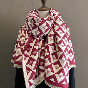 Close-up of red and beige V-shaped geometric pattern cashmere-like scarf with fringe