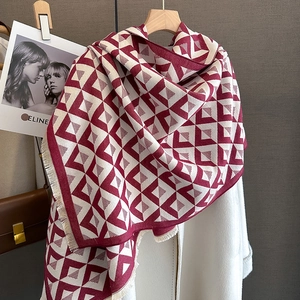 Detail of red and cream geometric triangle jacquard scarf with soft fringe tassels