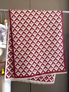 Detail of red and beige V-patterned pashmina shawl with delicate fringed edges