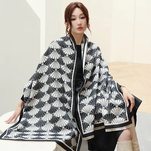 Close-up of black and white shell geometric pattern shawl with fine fringe edges