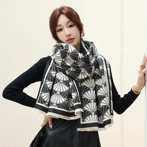 Detail of black and white fan-patterned thick cashmere scarf with fine fringe tassels