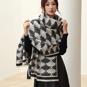 Detail of black and white fan pattern cashmere scarf with delicate tassel edges