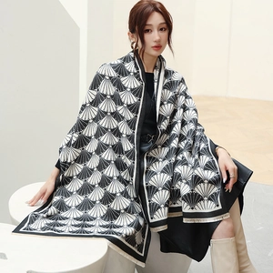Detail of classic black and white shell pattern pashmina shawl with tassel trim edges