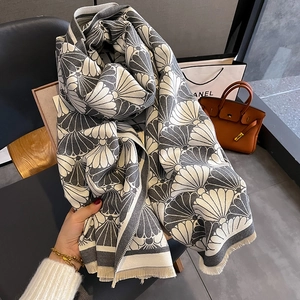 Fashionable grey and white cashmere-like shawl featuring elegant fan-shaped patterns