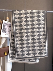 Detail of grey and white Art Deco fan pattern scarf with fringe and soft cashmere texture
