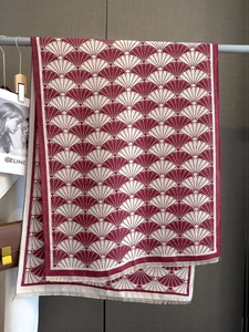 Detailed view of burgundy and cream shell pattern scarf with delicate fringe edges
