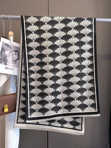 Close-up of black and white fan-patterned scarf with elegant fine fringe details