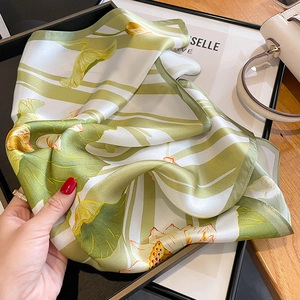 Elegant silk scarf with green lotus leaf and floral pattern on an ivory white background