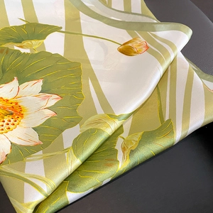 Silk square scarf with vintage lotus print and fine hand-rolled edges on dark background
