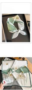 Détail du foulard en soie avec imprimé lotus vert et finition satinée haut de gamme