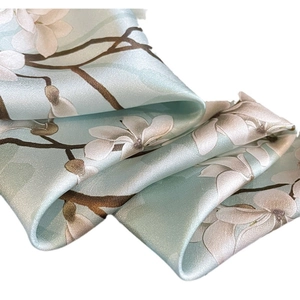 Elegant light blue silk scarf with white magnolia floral print and silky texture