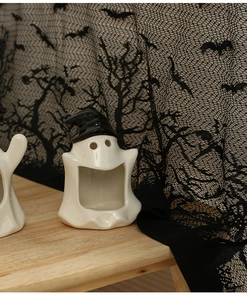 Ceramic Halloween ghost ornament with witch hat and open mouth on black lace