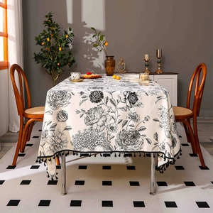 Elegant rectangular cotton linen tablecloth with black floral patterns and tassel edges