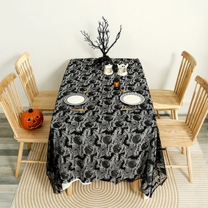 Black lace Halloween tablecloth featuring bat, pumpkin, and spider web patterns for party decor