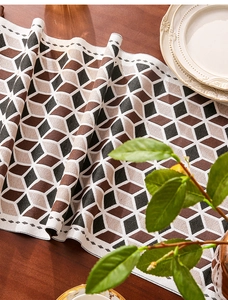 Detalle de camino de mesa jacquard geométrico 3D con textura tejida en mesa de madera