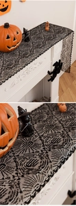 Detailed lace texture of black spider web fireplace scarf for Halloween home decor