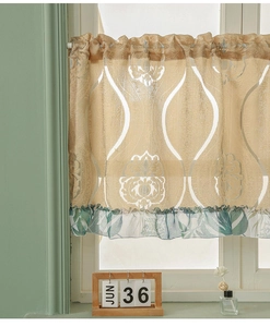 Detail of vintage champagne jacquard cafe curtain with green botanical ruffle trim finish