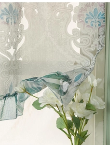 Detail of semi-transparent vintage curtain with fine embroidery and ruffled hem design