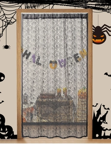 Detail of black lace Halloween door curtain with skull patterns and festive banner