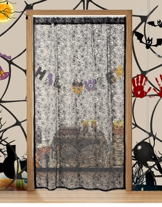 Detail of black lace Halloween door curtain featuring a dense spider web mesh pattern