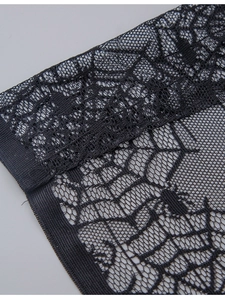 Close-up of black lace fabric with spider web patterns for Halloween decoration