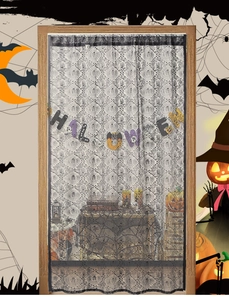 Detail of black lace Halloween curtain featuring intricate spider webs and skull patterns