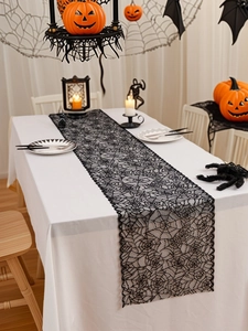 Detailed view of Halloween black lace table runner featuring intricate spider web patterns