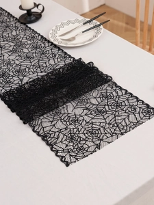 Close-up of black lace table runner with intricate geometric hollow mesh patterns