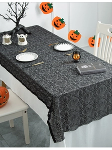 Detailed texture of black lace Halloween tablecloth with intricate spider web patterns