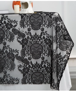 Detailed close-up of Halloween black lace tablecloth featuring skull and butterfly patterns