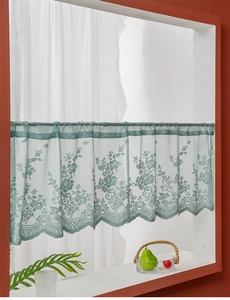 Close-up of light green lace cafe curtain with floral crochet and wavy scalloped edges
