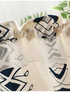 Detail of cafe curtain with navy geometric pattern on cream linen-cotton blend fabric