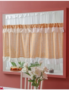 Detail of orange gingham cafe curtain with white ruffled edges for kitchen windows