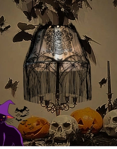 Detail of Halloween black lace lampshade featuring skull, bat patterns and fine fringe