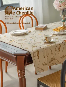Detailed close-up of thick chenille tablecloth featuring vintage floral and bird patterns