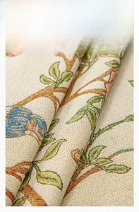 Close-up of luxury jacquard chenille fabric with bird and floral pattern for table decor