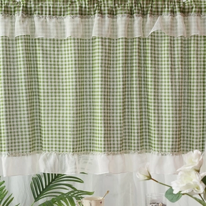 Green and white gingham cafe curtain with ruffle trim in rustic country style