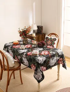 Close-up of chenille tablecloth featuring vintage red peony floral prints on black fabric
